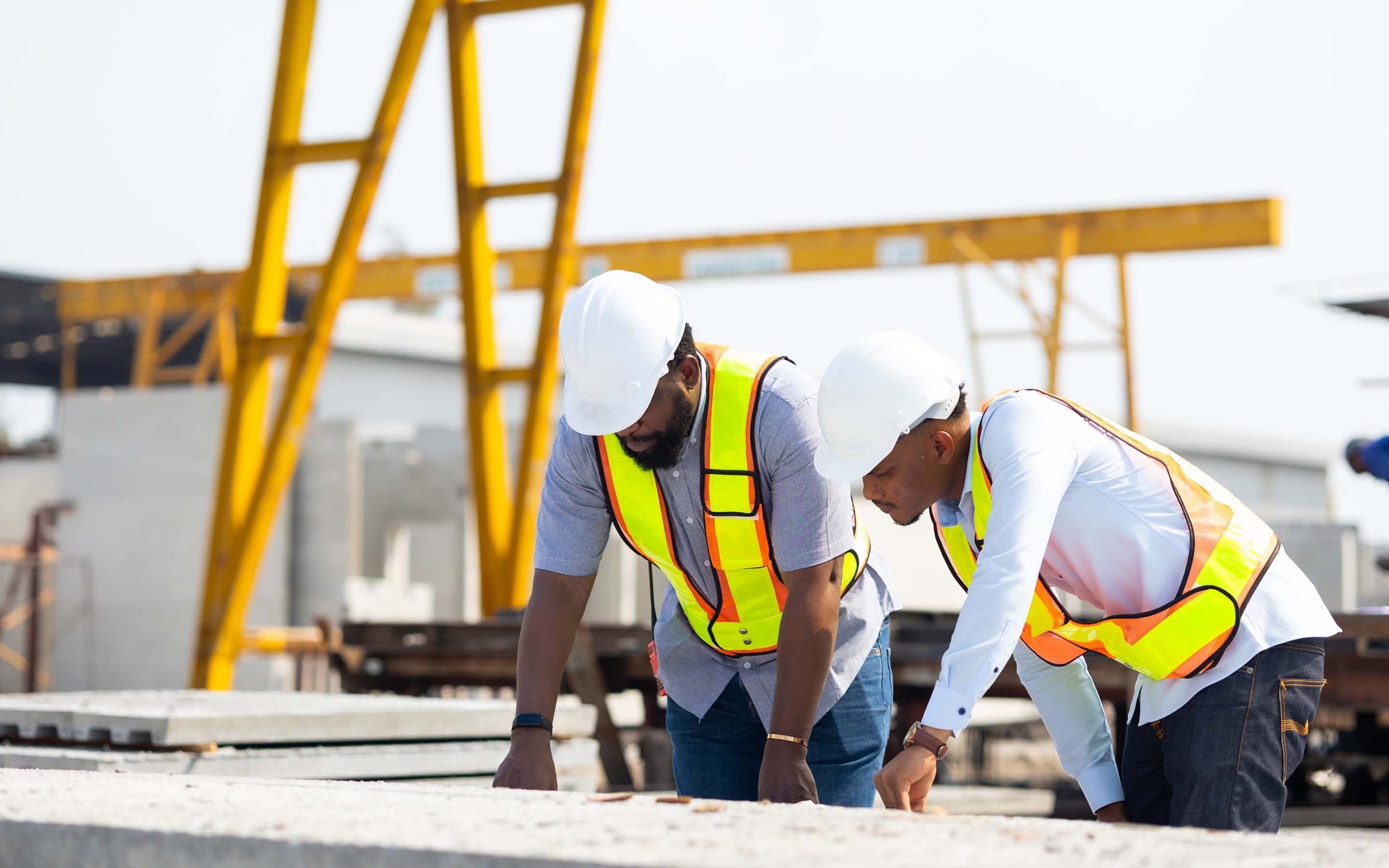 Large construction site with cranes and structural frameworks.